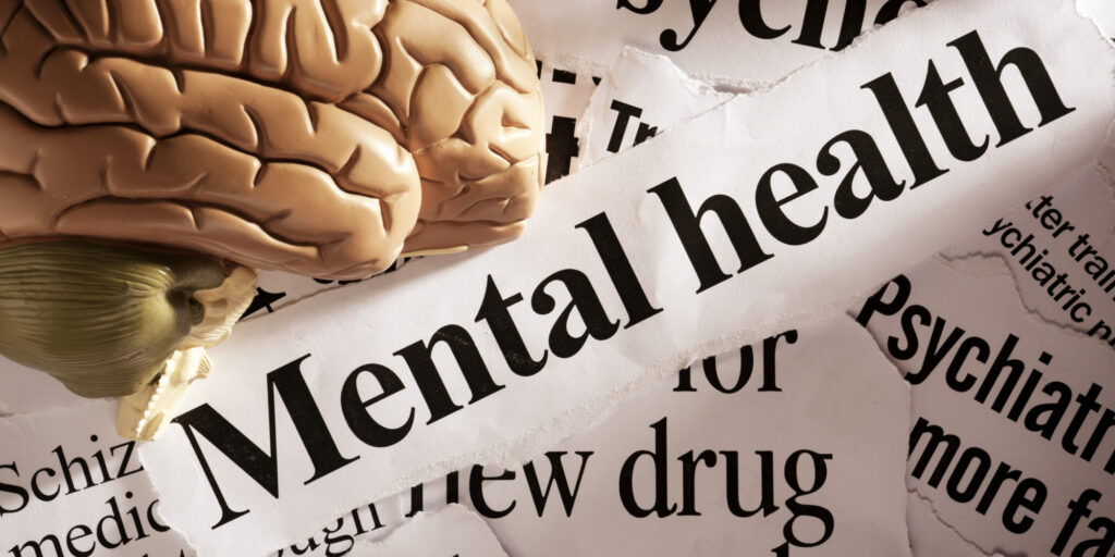 Close up of model brain on mental health headlines
